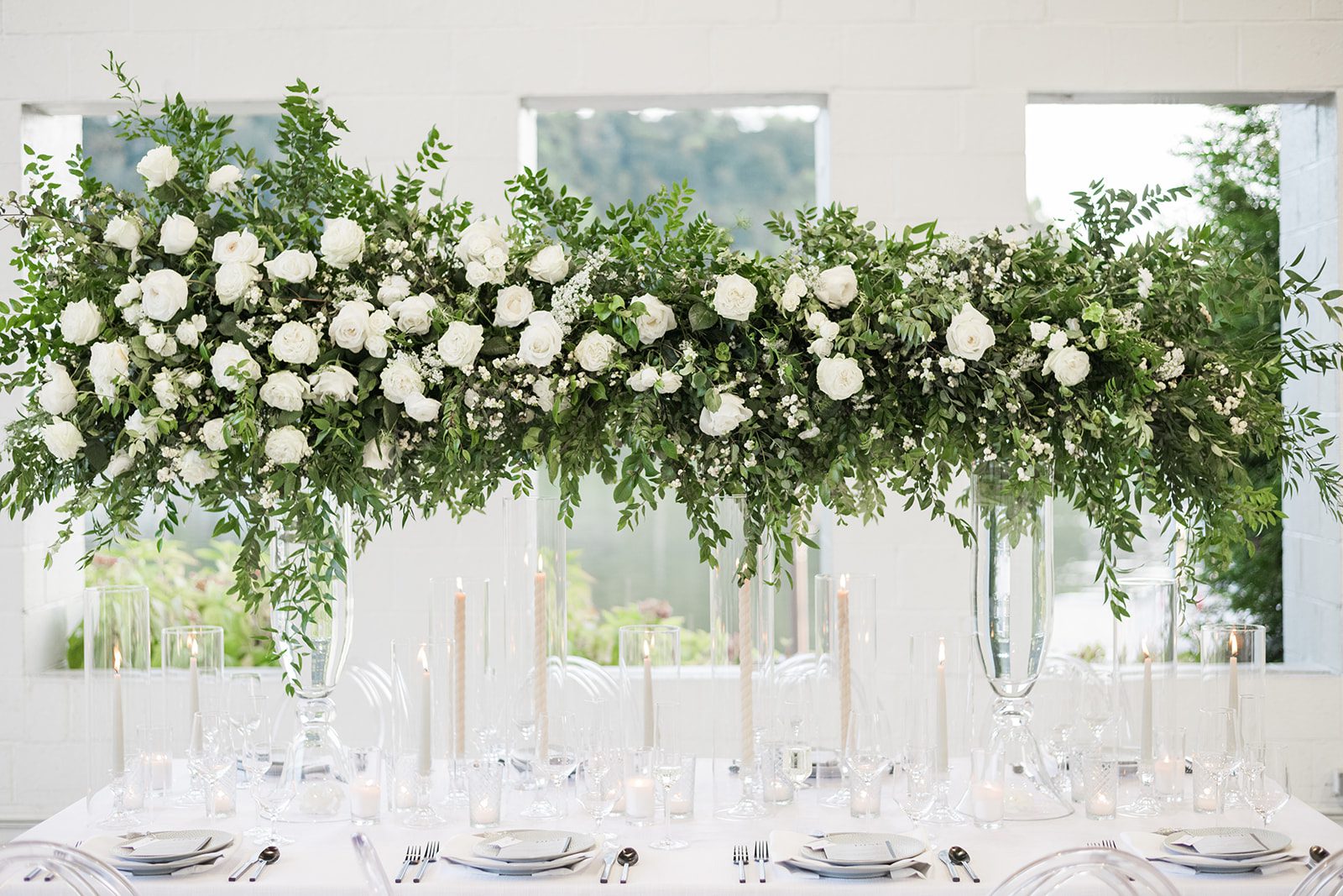 tall greenery white wedding reception table centerpiece candles riverfront weddings Levana Melamed photography Soiree by Souleret
