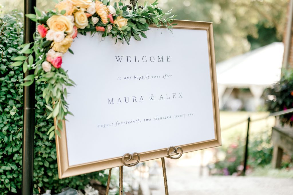 summer garden party welcome sign with floral and greenery corner accent