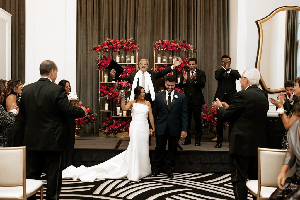 modern glamorous wedding ceremony newlyweds walking down aisle