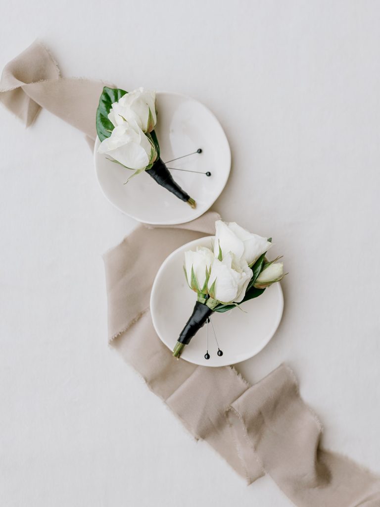 timeless winter wedding boutonnieres white flowers black ribbon