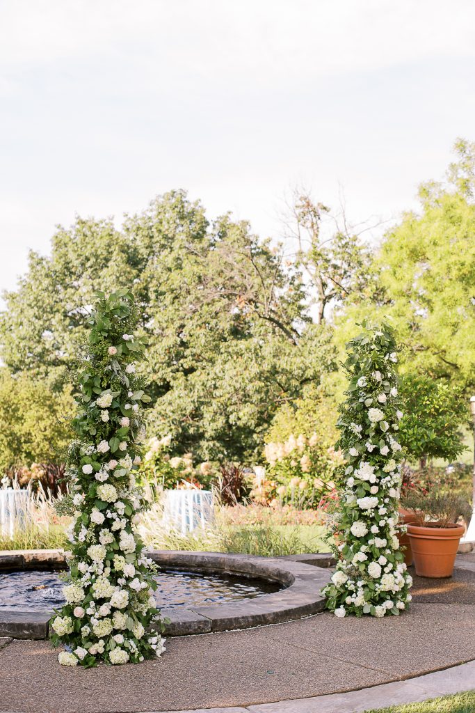 Floral columns wedding ceremony backdrop Phipps Conservatory outdoor garden