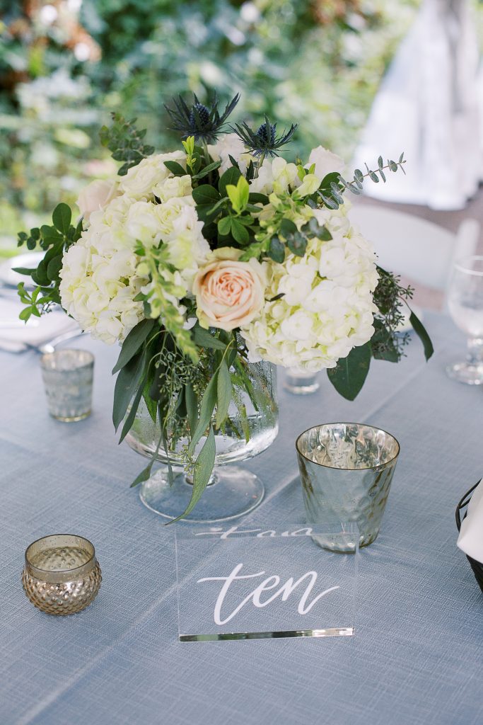 cool toned summer wedding reception guest table floral centerpiece