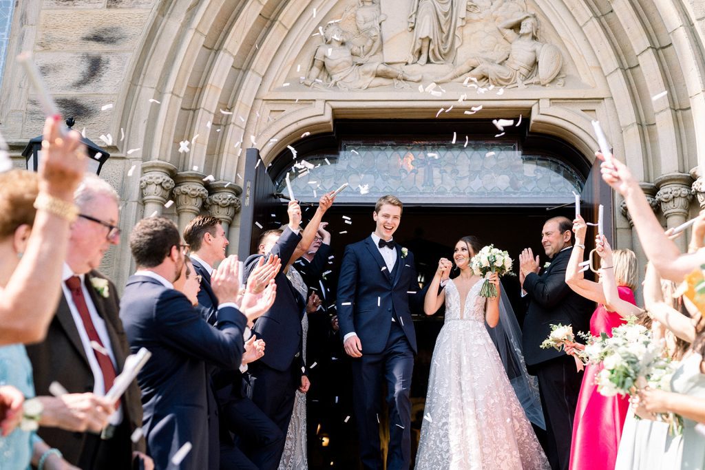 newlywed couple bride and groom exiting church after ceremony