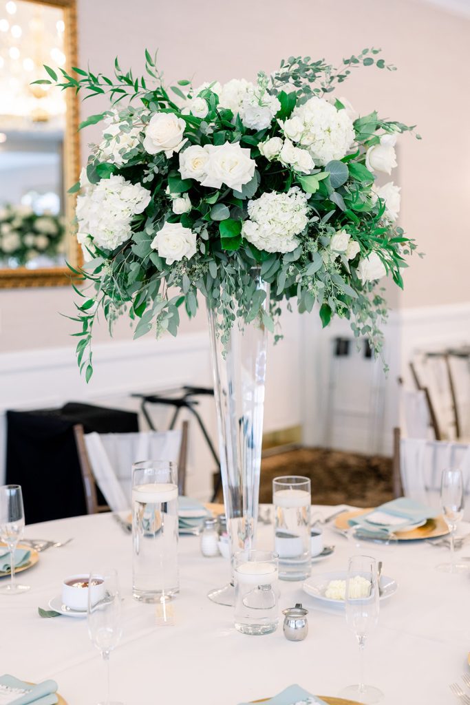 elegant bright wedding reception tall guest table centerpiece textural greenery and white flowers