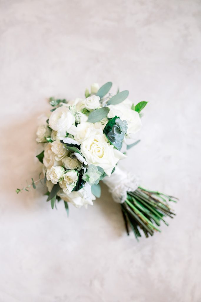 white and greenery bridal bouquet with dress lace handle wrap