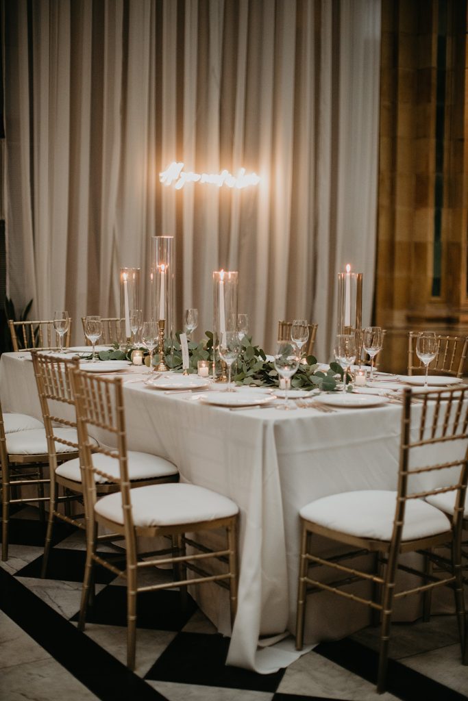 rectangular reception guest table with eucalyptus runner and candles